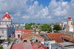 
There is an excellent view over the Parque Jose Marti in Cienfuegos from the roof bar of the Hotel la Union. On the left with the red cupola is the Palacio de Gobierno; the blue building at the end of the park is the Palacio de Ferrer; to the right is the Teatro Tomas Terry; and to the far right with a red cupola is the Catedral de la Purisima Concepcion (Cathedral of the Immaculate Conception).
